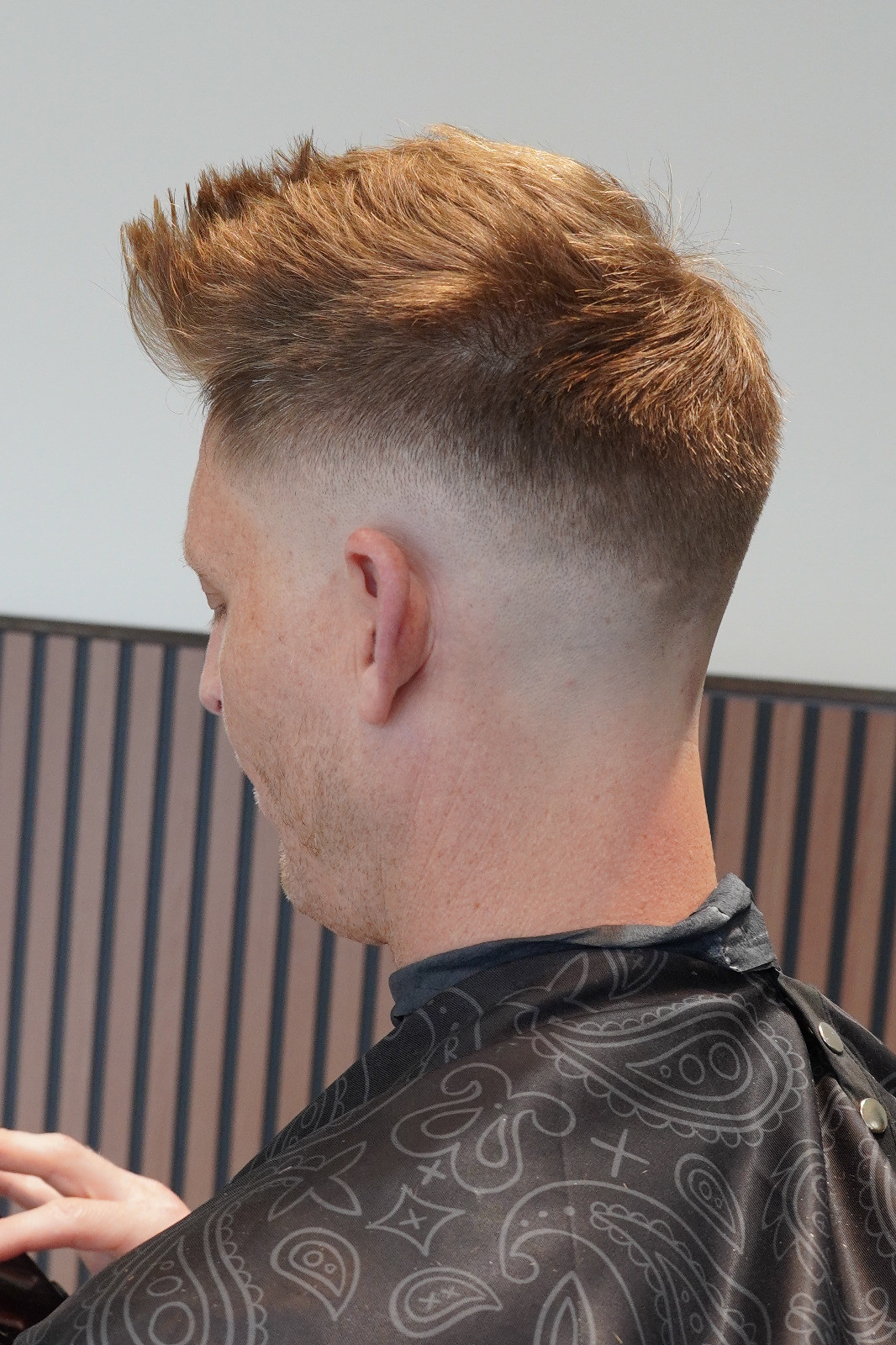 Barber performing a fade haircut